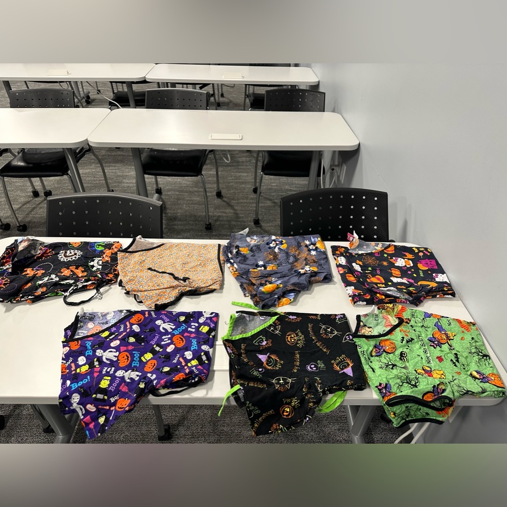 Ladies size xs (3) and small (4) Halloween scrub tops.